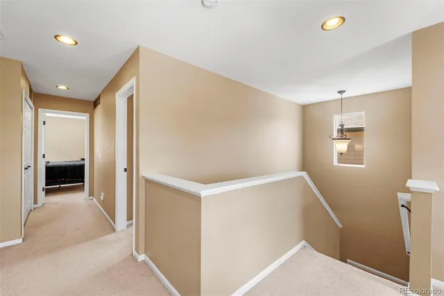 a view of hallway with bathroom and a bathroom