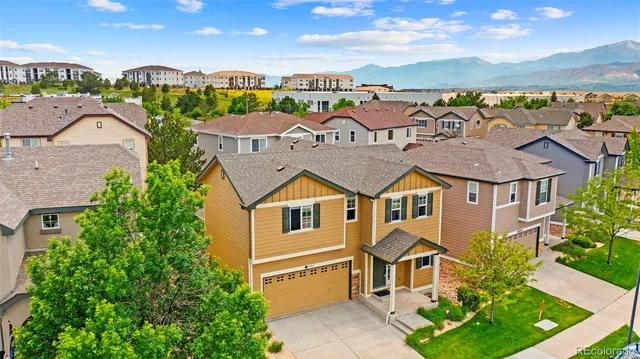 an aerial view of multiple houses with a yard