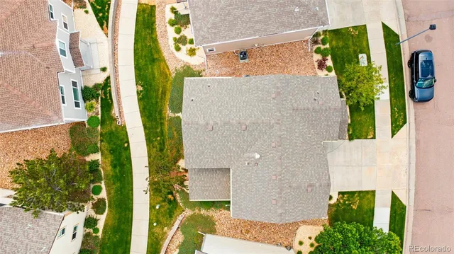 an aerial view of a house with a yard