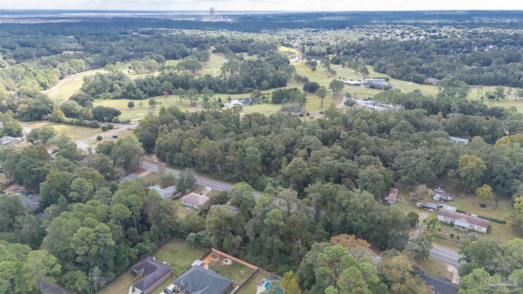 2290 Old Chemstrand Road Cantonment, FL 32533 - Photo 12 of 17 an aerial view of residential houses with outdoor space and trees