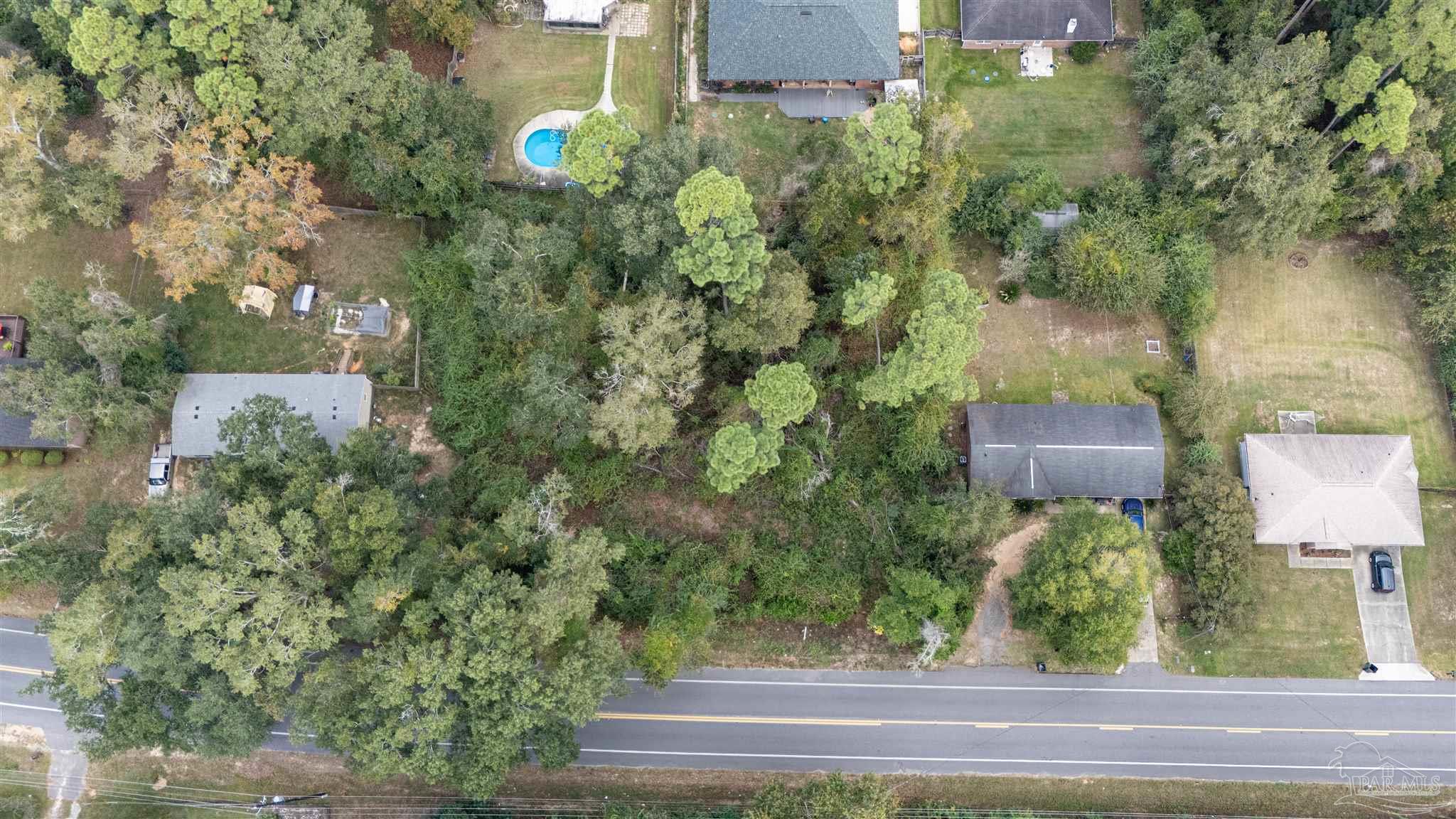 2290 Old Chemstrand Road Cantonment, FL 32533 - Photo 3 of 17 a view of a house and a yard and tree s