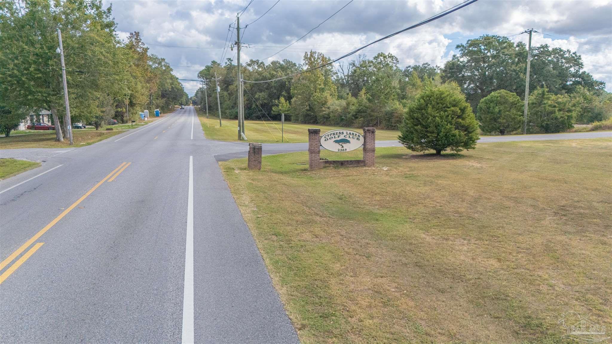 2290 Old Chemstrand Road Cantonment, FL 32533 - Photo 7 of 17 a view of a swimming pool with a yard