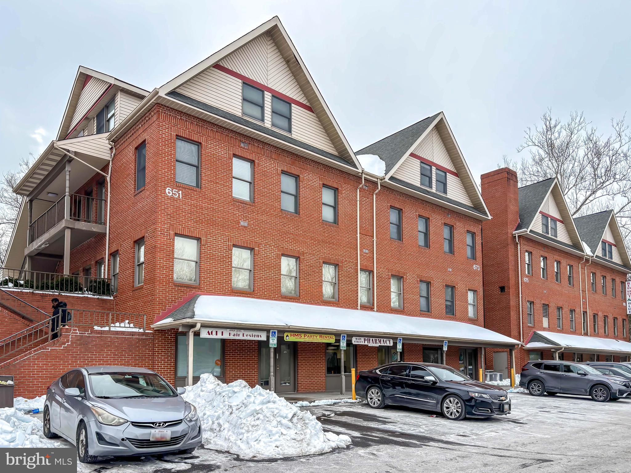 a front view of a building with table and chairs