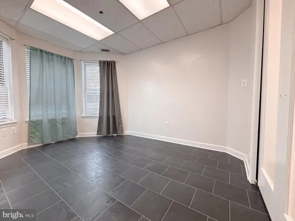 an empty room with wooden floor and a window