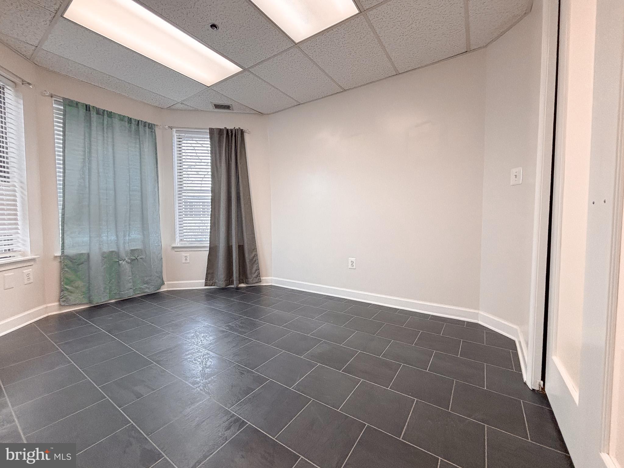 657 A Main Street, Unit A Laurel, MD 20707 - Photo 17 of 25 an empty room with wooden floor and a window