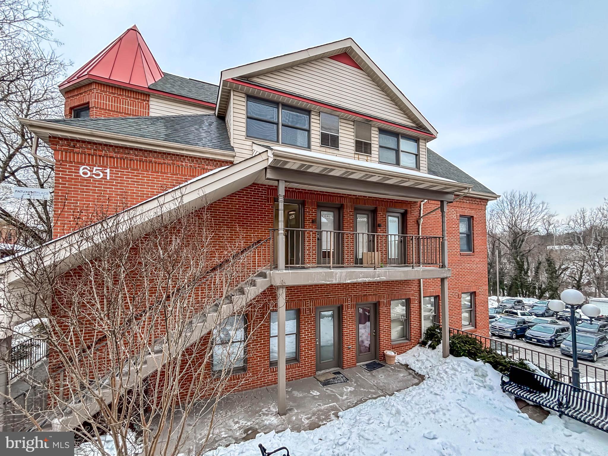 657 A Main Street, Unit A Laurel, MD 20707 - Photo 2 of 25 a front view of a house with a yard