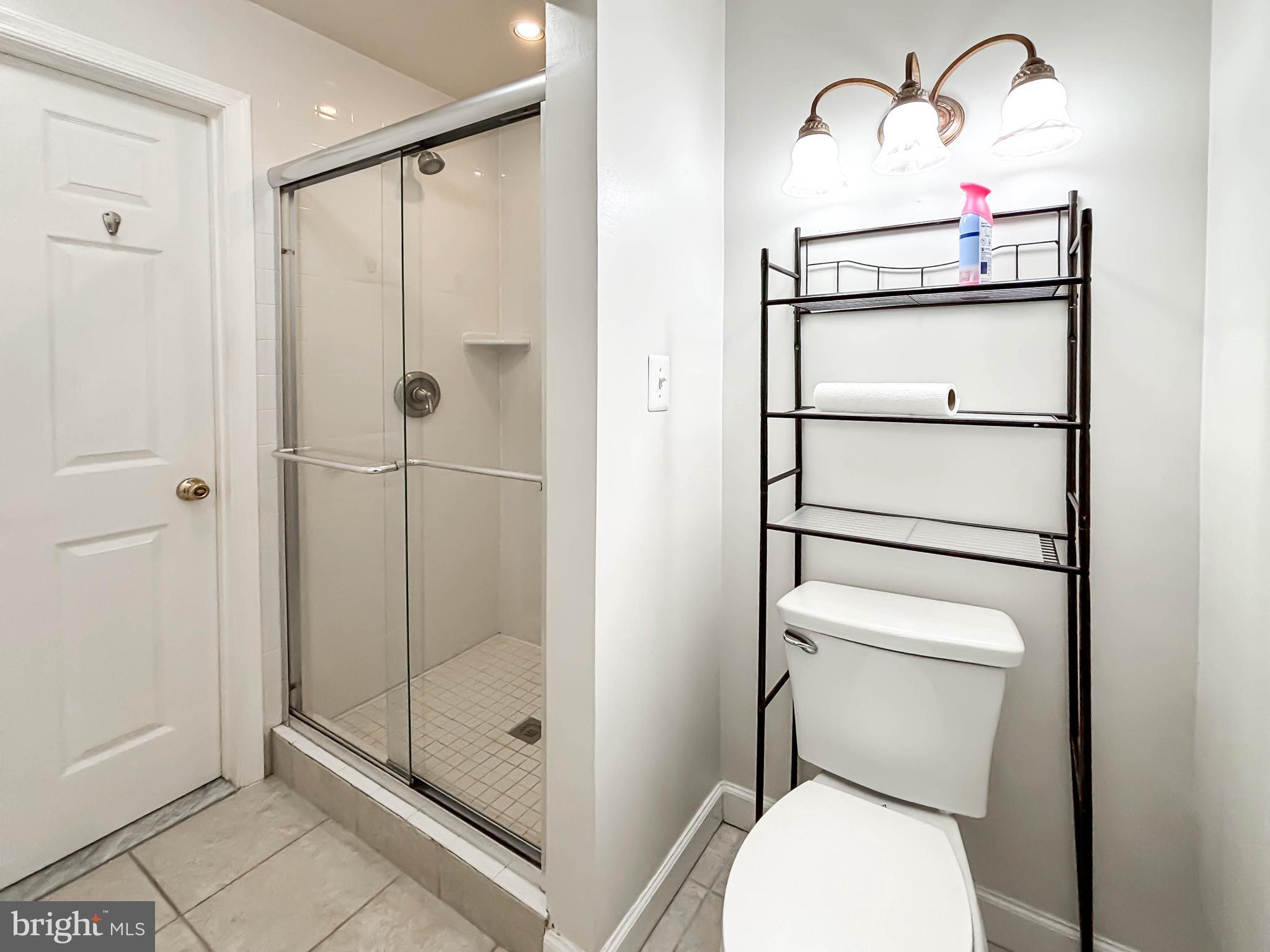 657 A Main Street, Unit A Laurel, MD 20707 - Photo 24 of 25 a bathroom with a toilet and a shower