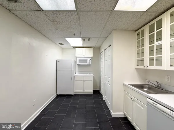a kitchen with refrigerator and cabinets