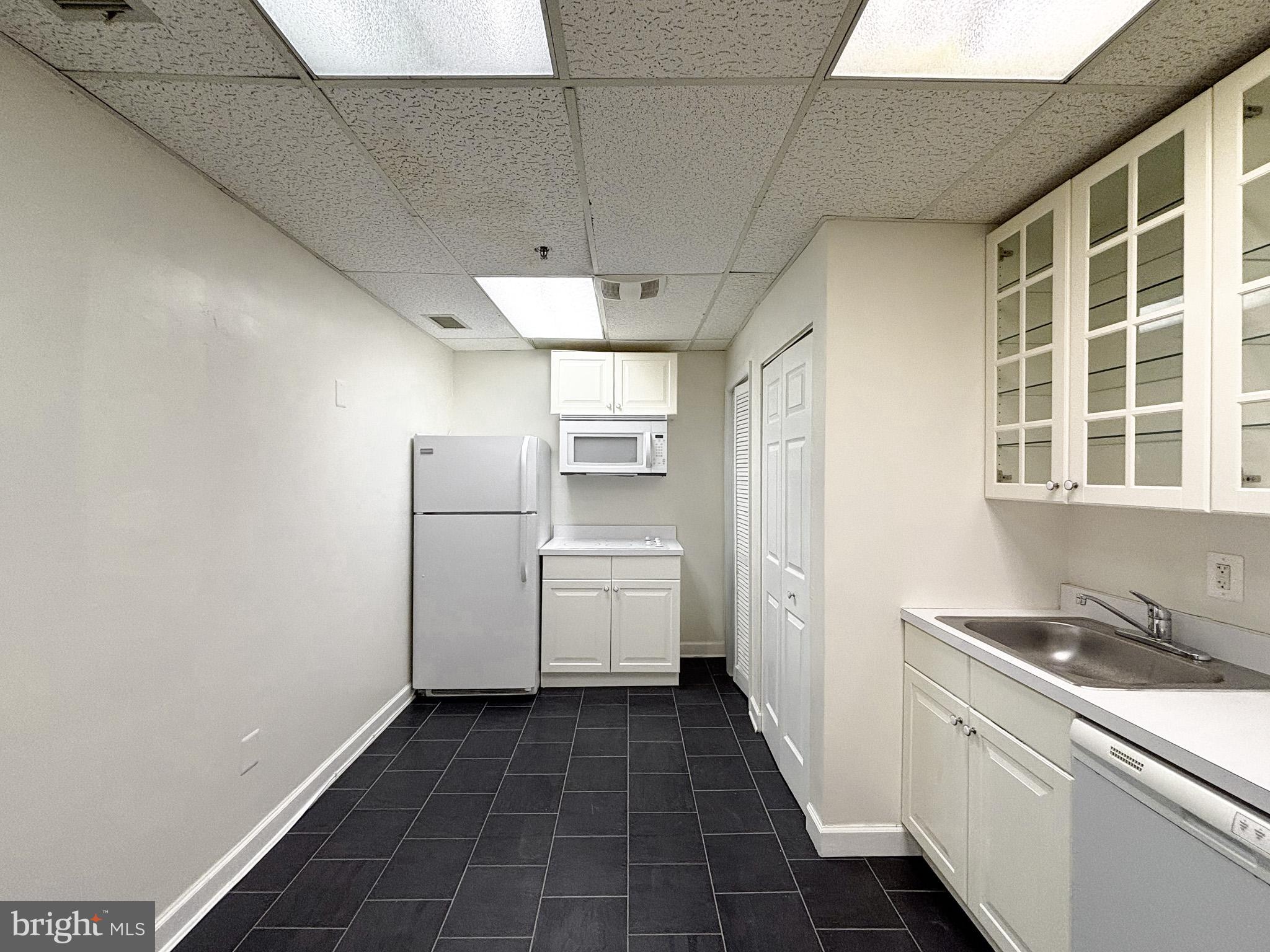 657 A Main Street, Unit A Laurel, MD 20707 - Photo 6 of 25 a kitchen with refrigerator and cabinets