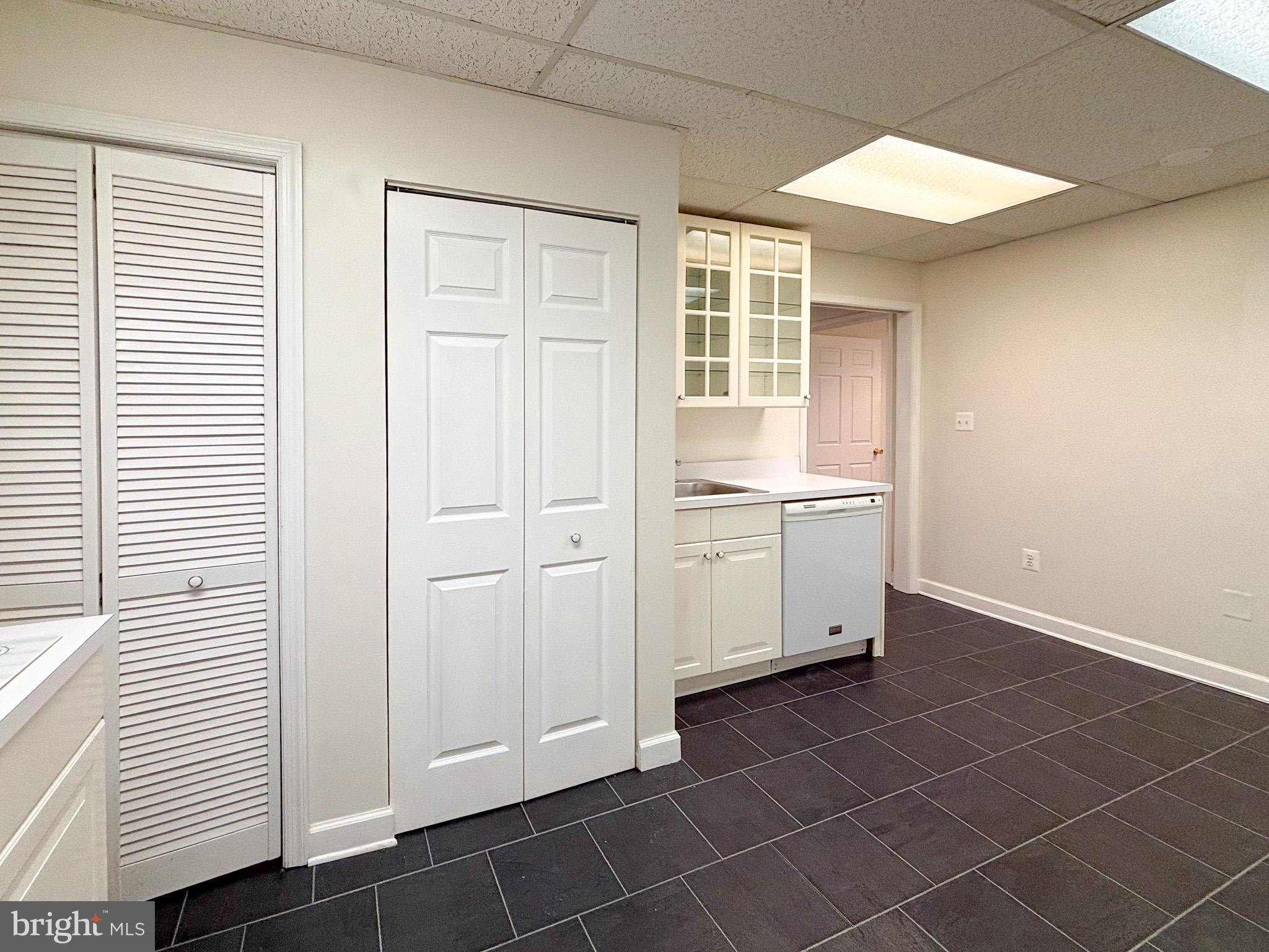 657 A Main Street, Unit A Laurel, MD 20707 - Photo 8 of 25 an empty room with windows and cabinet