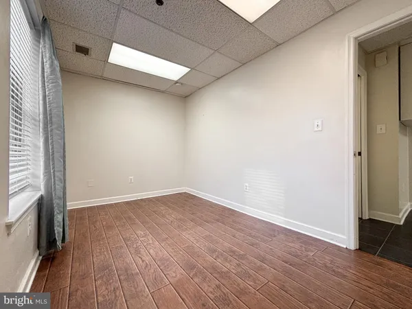 a view of a room with wooden floor