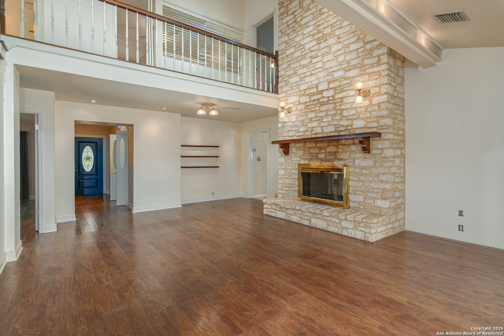 2981 Vivroux Ranch Road Seguin, TX 78155 - Photo 19 of 50 an empty room with wooden floor and fireplace