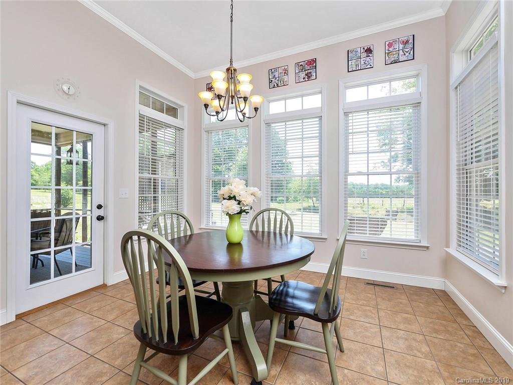 4657 Hickory Grove Road Sharon, SC 29742 - Photo 12 of 32 a dining room with furniture a chandelier and wooden floor