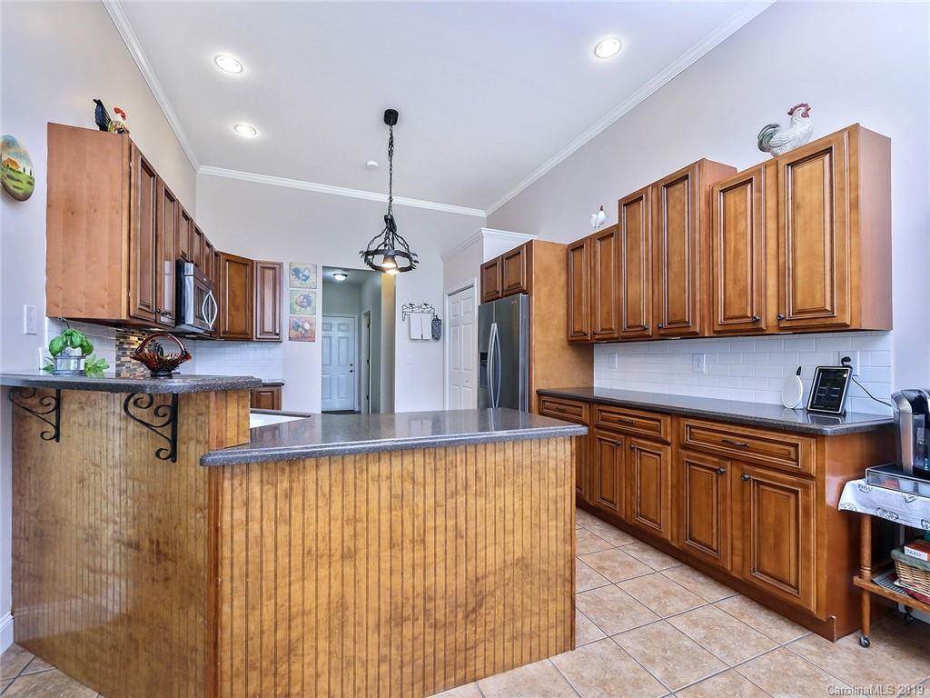 4657 Hickory Grove Road Sharon, SC 29742 - Photo 10 of 32 a kitchen with stainless steel appliances granite countertop a sink a stove and a wooden cabinets