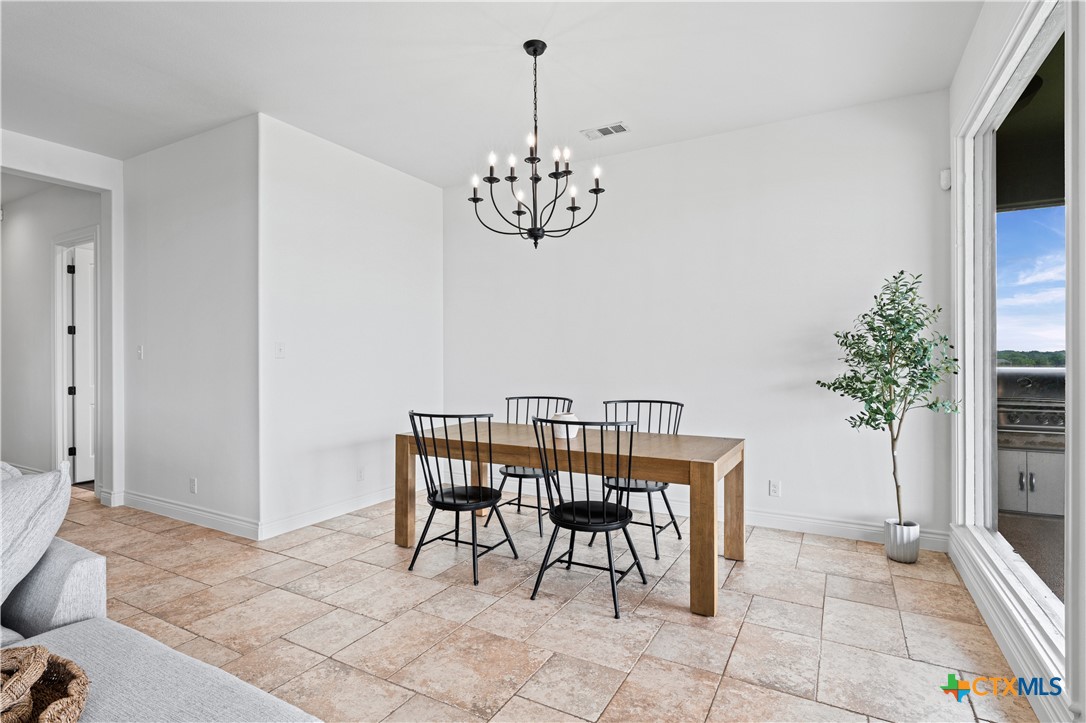 11023 Bigham Road Troy, TX 76579 - Photo 19 of 42 a view of a dining room with furniture and chandelier