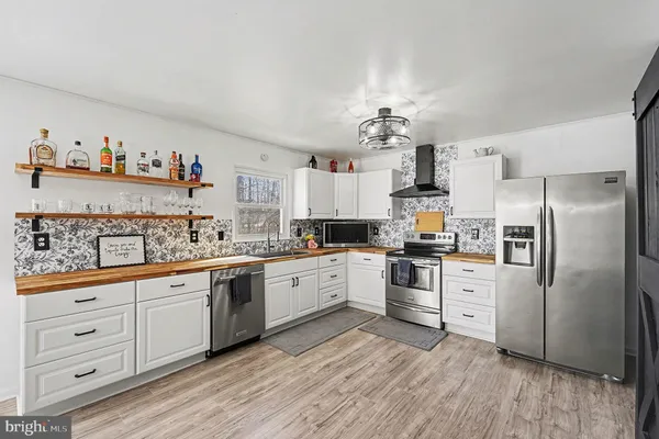 a view of kitchen and dining room with wooden floor