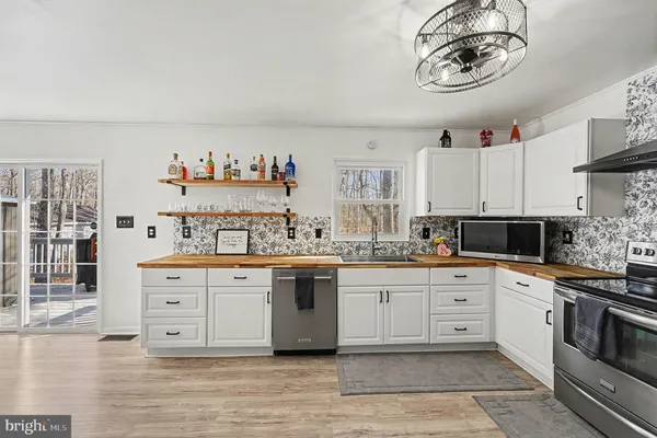 a kitchen with cabinets a sink and appliances