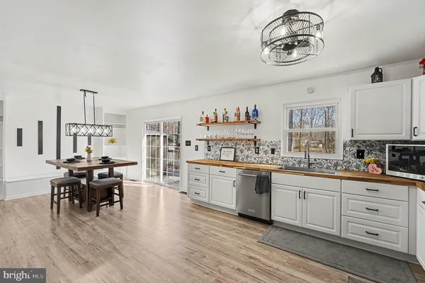 a view of a patio with table and chairs and wooden floor