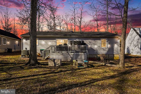 a view of a house with a yard covered with snow