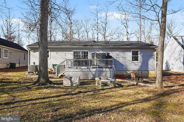 a view of a house with a yard covered in snow