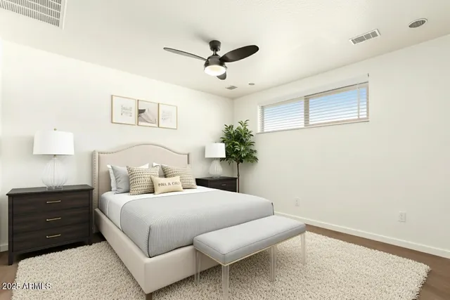 a bedroom with a bed chandelier and a window
