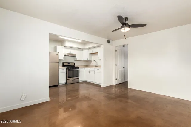 a view of a kitchen with a sink and dishwasher a refrigerator with wooden floor