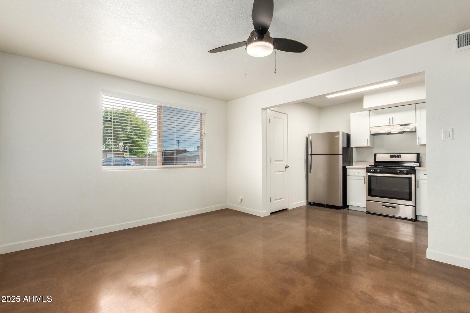 616 South Bellview, Unit C Mesa, AZ 85204 - Photo 4 of 19 a view of a kitchen with refrigerator and wooden floor