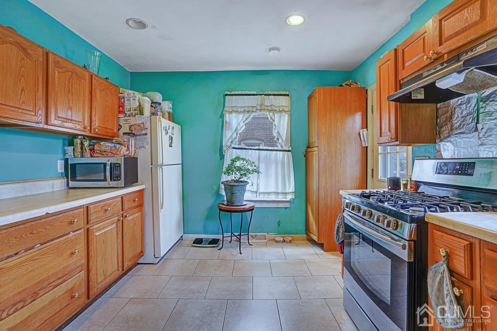 708 Front Street Dunellen, NJ 08812 - Photo 7 of 19 Kitchen has recessing lighting/new stove and ceramic tile floor