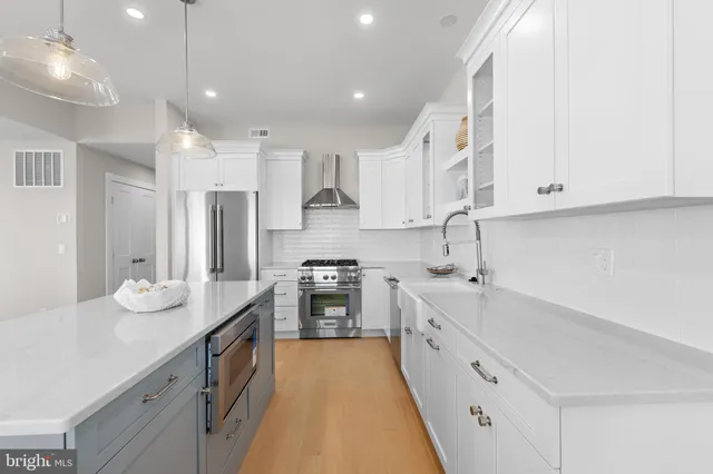 a view of a dining room and livingroom with furniture a chandelier