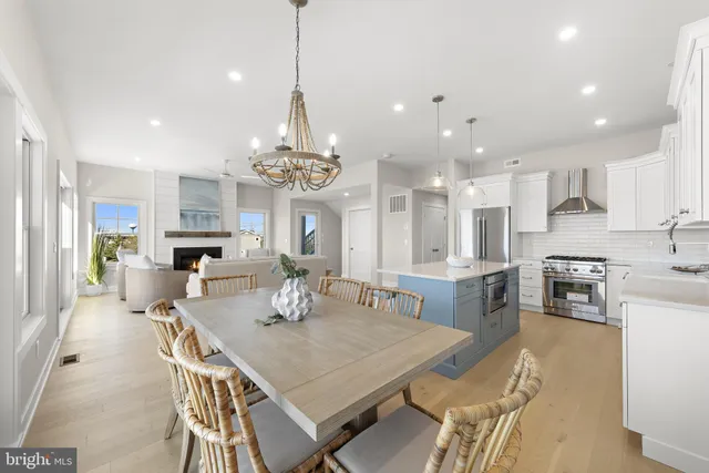 a view of a dining room with furniture wooden floor and chandelier
