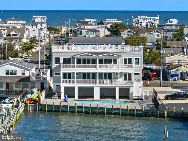 a living room with furniture a fireplace and a dining table with kitchen view