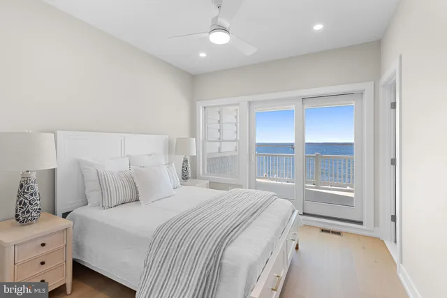 a bathroom with a toilet a sink a glass door a shower and a mirror