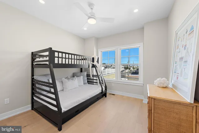 a bathroom with a toilet a sink a mirror a bathtub and vanity