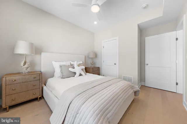 a kitchen with stainless steel appliances white cabinets and a window