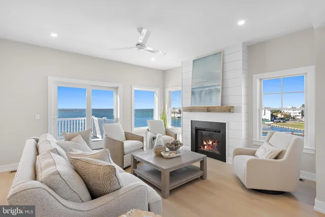 a living room with furniture and a dining table with kitchen view