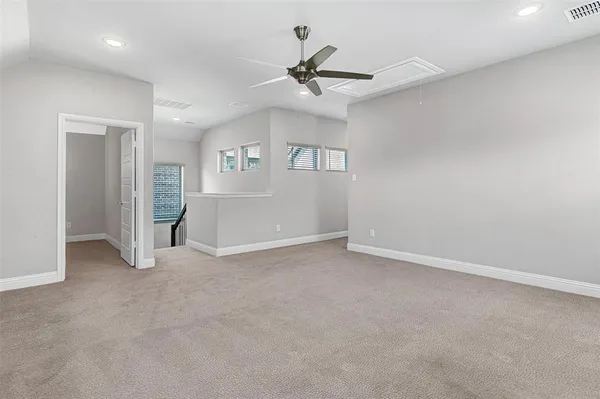 an empty room with closet and windows