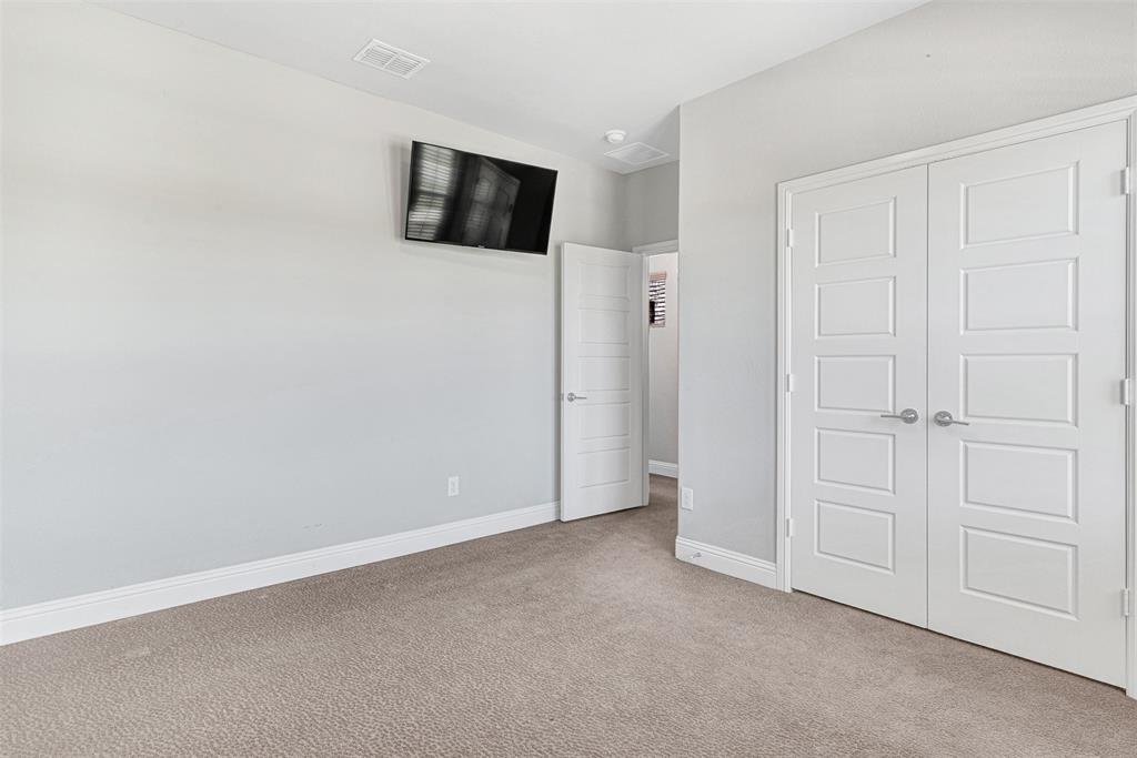 468 Caitlyn Way Fairview, TX 75069 - Photo 33 of 35 Unfurnished bedroom featuring light colored carpet and a closet