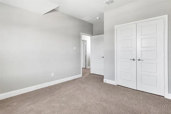 an empty room with closet area
