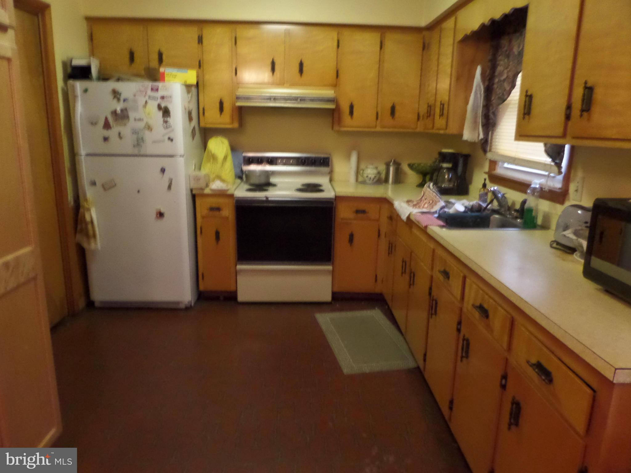 21240 Dover Bridge Road Preston, MD 21655 - Photo 9 of 13 a kitchen with a refrigerator stove and sink