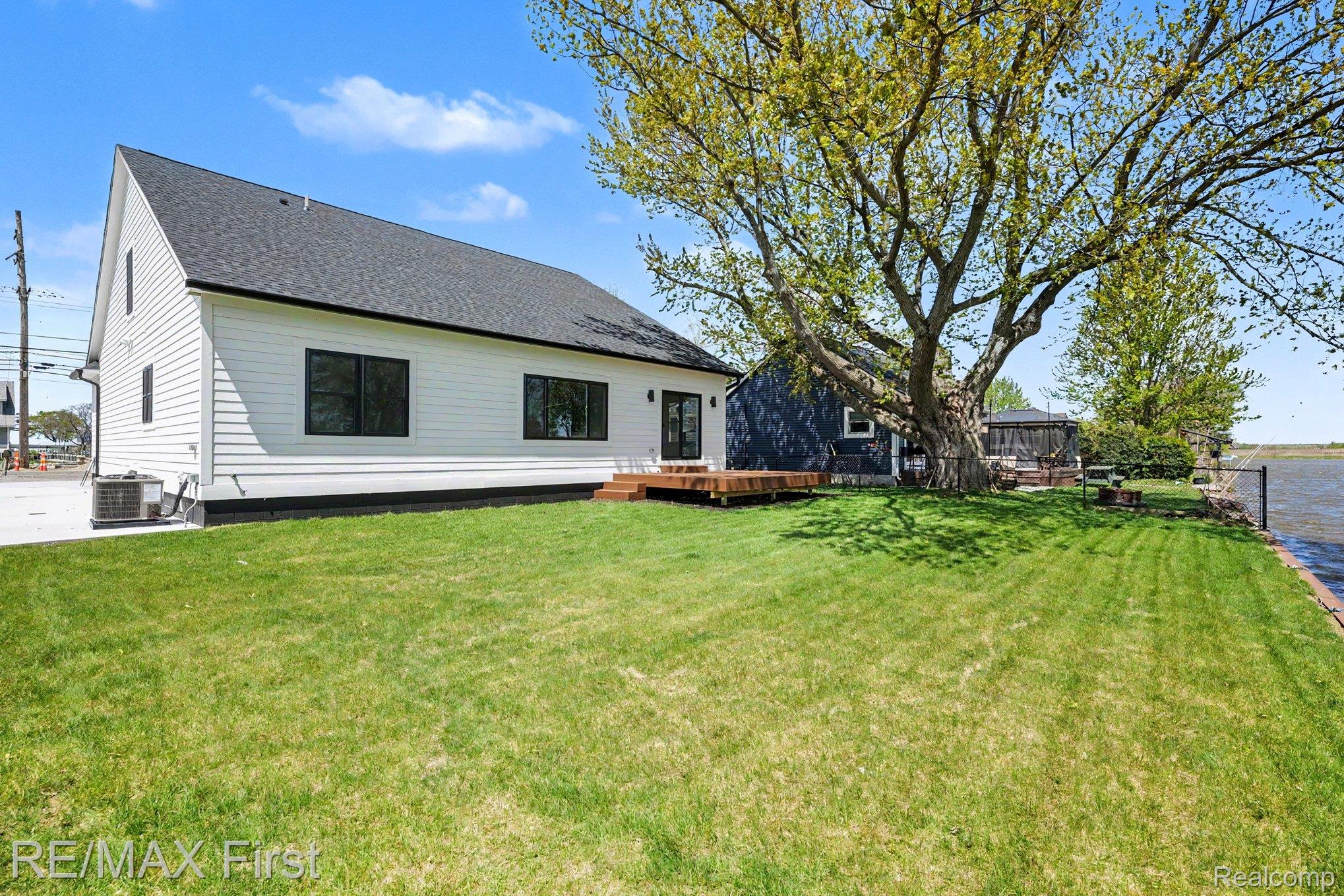 7424 Dyke Road Algonac, MI 48001 - Photo 27 of 31 Rear view of property featuring a wooden deck and a shingled roof