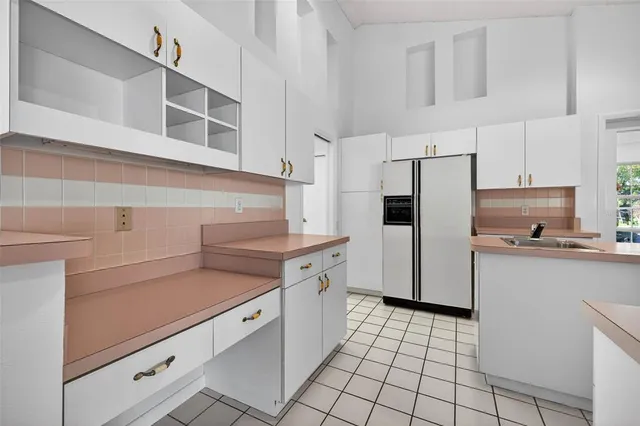 a kitchen with stainless steel appliances a sink and cabinets