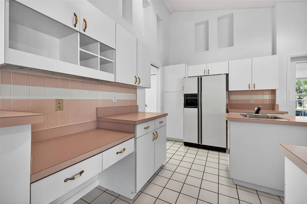 1819 Tree Swallow Way Palm Harbor, FL 34683 - Photo 11 of 37 a kitchen with stainless steel appliances a sink and cabinets