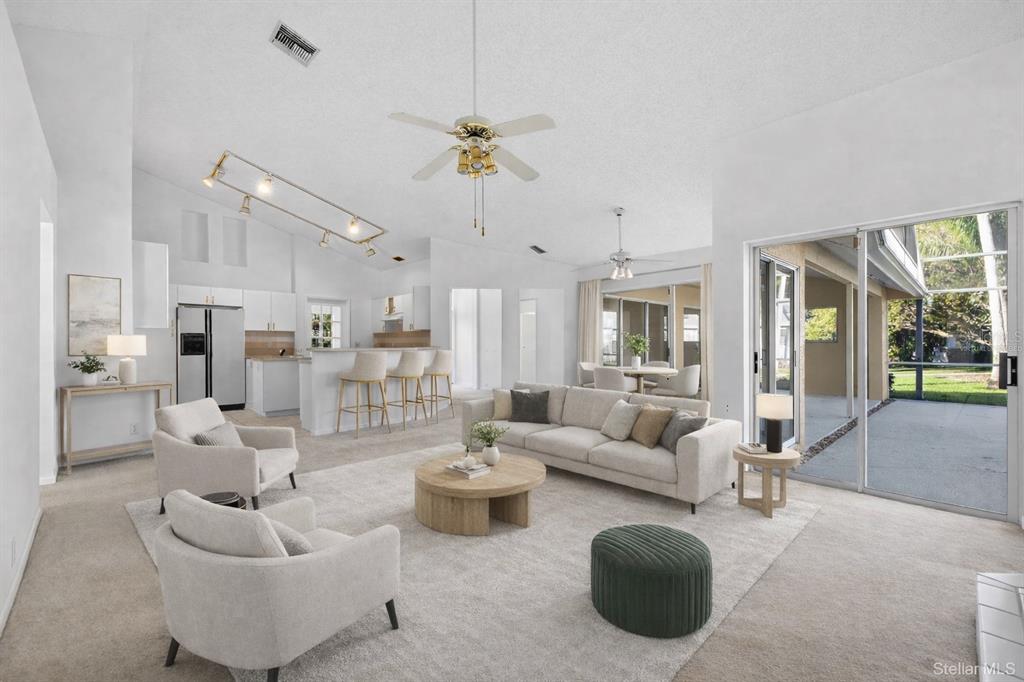 1819 Tree Swallow Way Palm Harbor, FL 34683 - Photo 12 of 37 a living room with furniture kitchen view and a chandelier