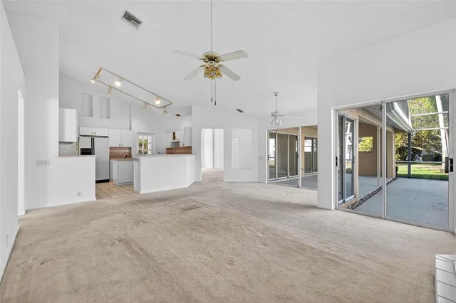 a view of a kitchen with refrigerator and a sink