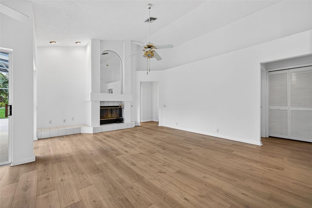 1819 Tree Swallow Way Palm Harbor, FL 34683 - Photo 15 of 39 a view of empty room with wooden floor and fireplace