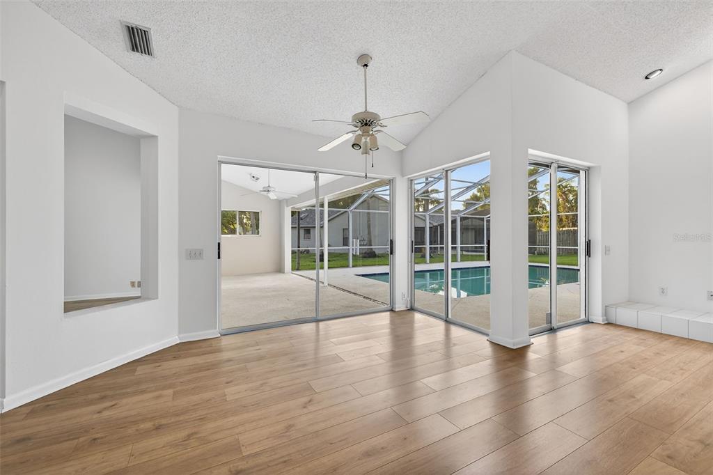 1819 Tree Swallow Way Palm Harbor, FL 34683 - Photo 16 of 39 a view of an empty room with wooden floor and a window