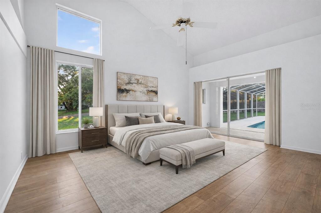 1819 Tree Swallow Way Palm Harbor, FL 34683 - Photo 17 of 39 a spacious bedroom with a large bed and a window