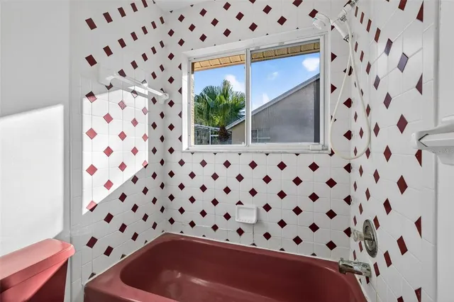 a bathroom with a toilet and a shower curtain