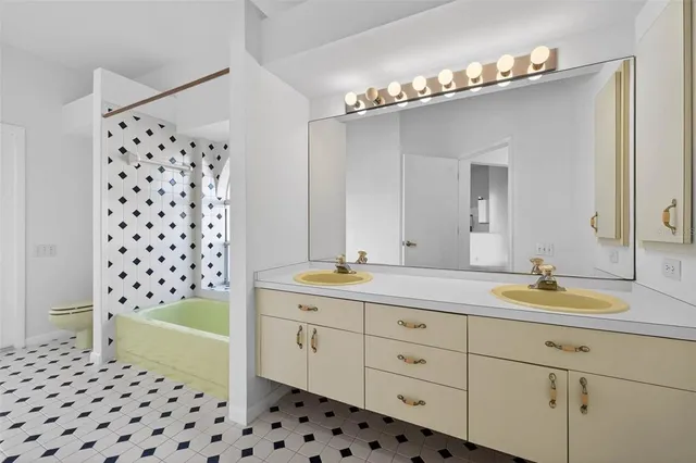 a bathroom with a double vanity sink mirror and shower