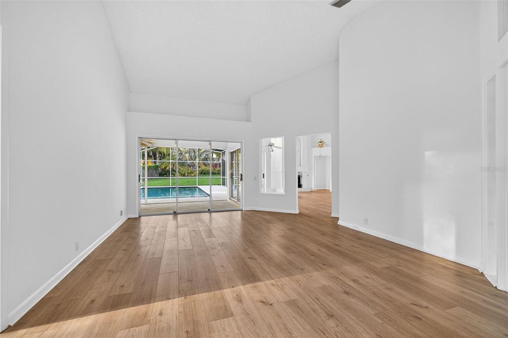 1819 Tree Swallow Way Palm Harbor, FL 34683 - Photo 3 of 39 a view of an empty room with wooden floor and a window